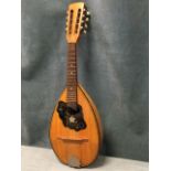 A Lignatone eight string mandolin, the gourd shaped walnut body inlaid with ebony stringing,