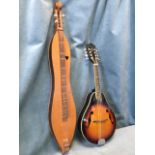 A Harmony eight string mandolin with inlaid fingerboard and stained body with ivory coloured