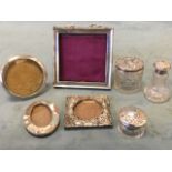 Four Victorian hallmarked silver photograph frames - circular, swag embossed, oval and square