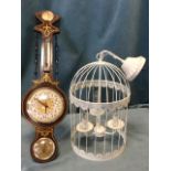 A decorative wallclock in the form of a nineteenth century barometer; and a painted hanging cage