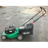 A Qualcast rotary garden mower with Briggs & Stratton petrol engine.