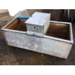 A rectangular galvanised trough with tubular rim, the central lidded section with cistern ball valve