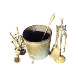 A brass coal bucket with liner on paw feet; a brass poker with turned handle; and two brass firetidy