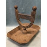 A nineteenth century cast iron bootscraper, the rectangular canted tray with horseshoe shaped ribbed