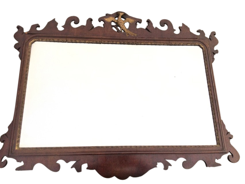 A Chippendale mahogany mirror with rectangular bevelled plate in fretwork cut frame surmounted by