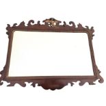 A Chippendale mahogany mirror with rectangular bevelled plate in fretwork cut frame surmounted by