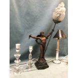 A reproduction art nouveau style tablelamp modelled as a draped figure holding a torch aloft, on