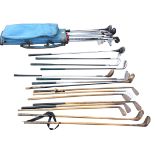 Twenty eight golf clubs, including eight hickory shafted, a 70s golf bag, putters, woods, etc. (29)