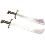 A pair of Indian sabres with plated steel ribbed blades, and brass cast handles in the form of