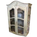 A painted nineteenth century Dutch oak bowfronted display cabinet, with arched moulded cornice