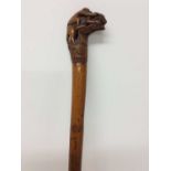 19th century carved bamboo cane, the terminal carved with a monkey riding a hound, on foliate carved