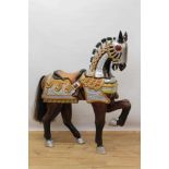 Highly decorative carved and polychrome painted wooden horse