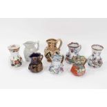 A rare Masons Ironstone relief moulded jug, five other Masons jugs and two tooth brush vases