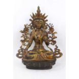 Tibetan gilt bronze figure of a seated goddess