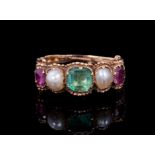 Regency emerald, ruby and pearl ring with a central step cut emerald, two half pearls and two oval m