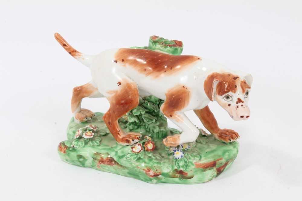 Late 18th century Derby porcelain model of a Pointer, shown mid-stride on a grassy base, 16cm length