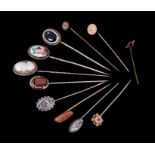 Group of eleven antique stick pins to include Victorian carved shell cameo stick pin