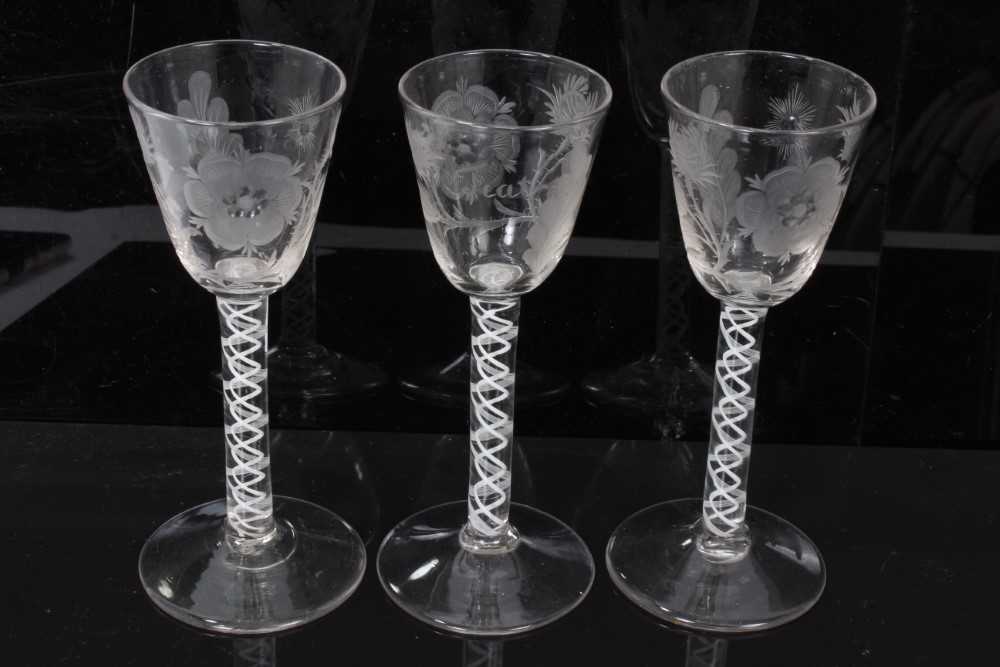 Georgian cordial glasses comprising a pair with Jacobite engraved rose, thistle, star and leaf decor