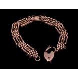 Edwardian 9ct rose gold gate bracelet with padlock clasp, approximately 20cm length.