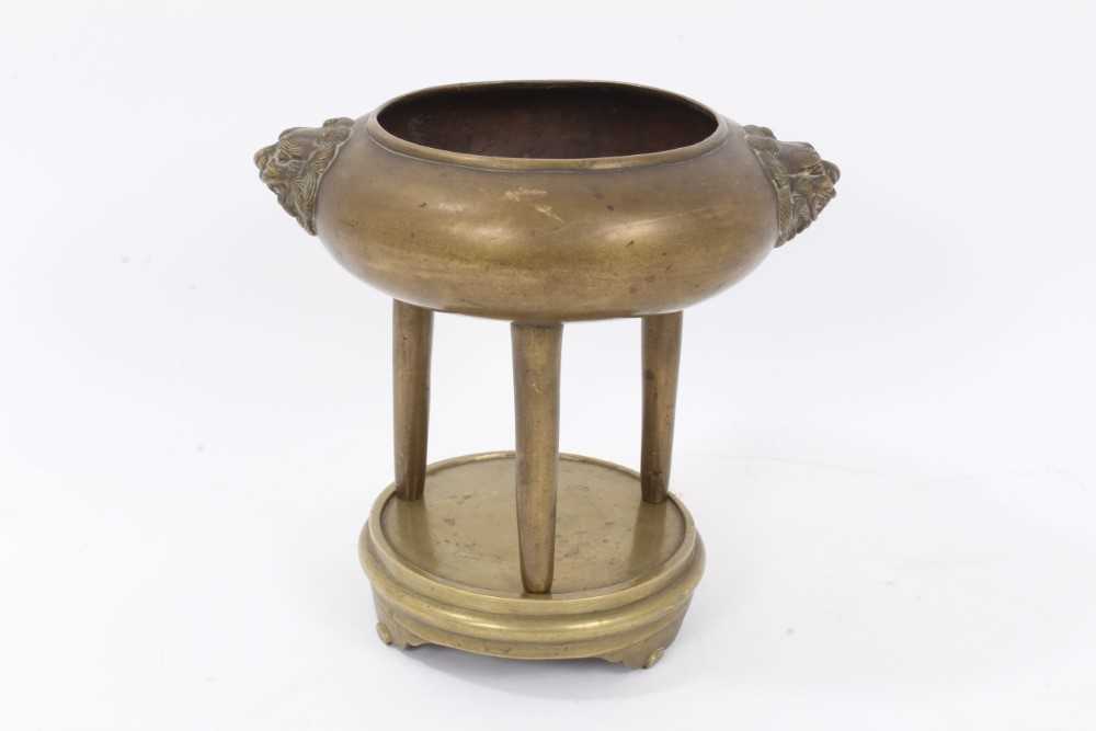 19th century Chinese bronze tripod censer on stand, with lion mask handles