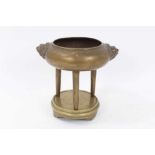 19th century Chinese bronze tripod censer on stand, with lion mask handles