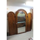 Unusual Victorian mahogany triple wardrobe with triple domed top, central mirrored door