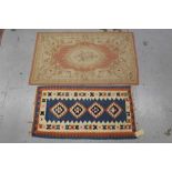 Kelim rug together with an Aubusson style rug
