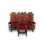 Set of eight Victorian baroque style carved oak dining chairs, each with arched upholstered pad back