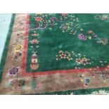 Chinese washed carpet on green ground with lantern and floral decoration