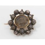 George III diamond brooch with an oval glazed compartment containing platted hair surrounded by a bo