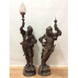 An impressive pair of spelter lamps in the form of warriors in armour holding lamps aloft
