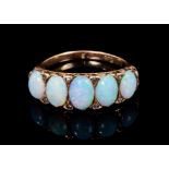 Late Victorian opal five stone ring with five graduated oval cabochon opals in carved gold setting w