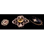 Victorian gold black onyx and seed pearl mourning brooch with star motif and glazed locket compartme