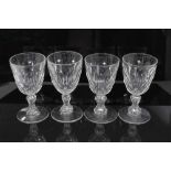 Set of four antique Georgian cut glass goblets, with facet-cut round funnel bowls, and facet-cut wai