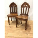 Pair of Victorian gothic mahogany hall chairs