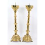 Pair of large 19th century gothic brass church pricket candlesticks together with a similar table/fl
