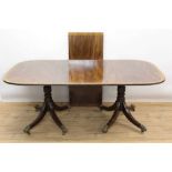 Regency and later mahogany and crossbanded twin pillar dining table in the Irish style