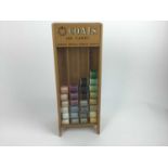 Coats 100 Yards cotton reel display with some cottons.