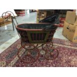 Victorian style wooden handled pram with metal wheels