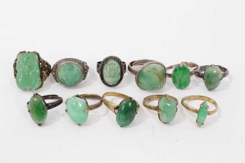 Eleven Chinese green hardstone/jade rings