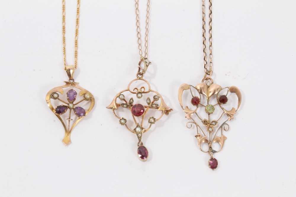 Three Edwardian 9ct gold seed pearl and gem set open work pendants on 9ct gold chains