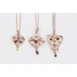 Three Edwardian 9ct gold seed pearl and gem set open work pendants on 9ct gold chains