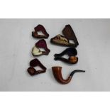 Six antique meerschaum pipes to include one depicting a gun dog carrying a hare