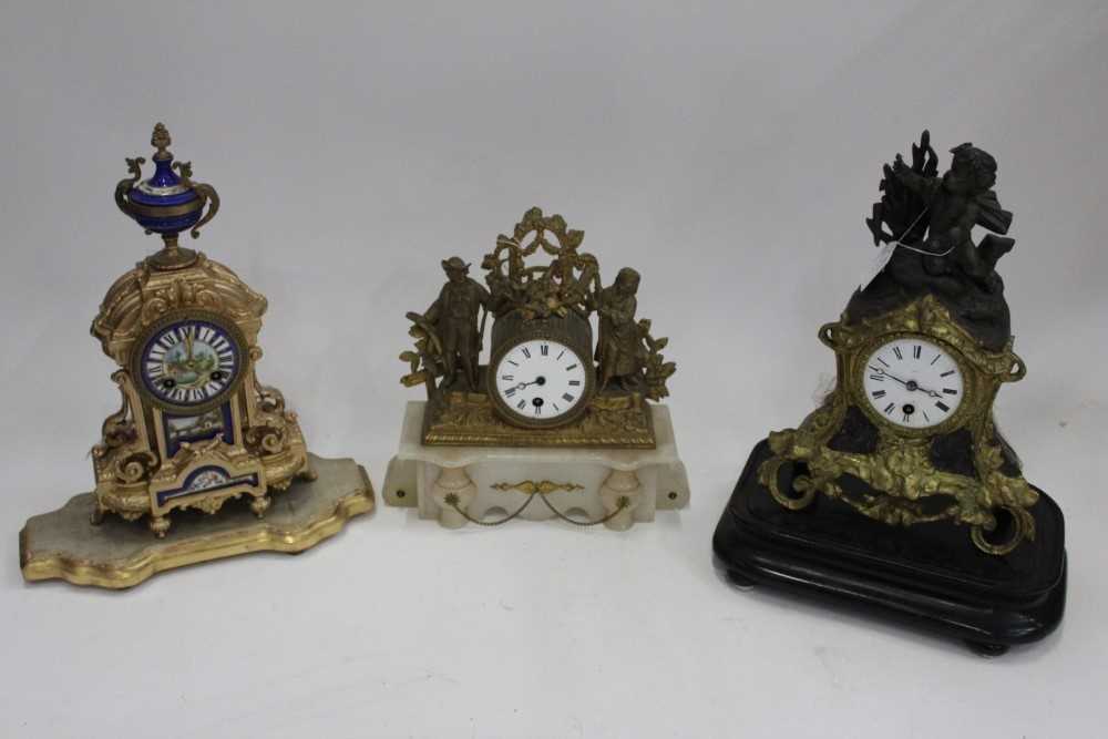 Three French mantel clocks, including an ormolu and onyx figural example, an ormolu and spelter cher