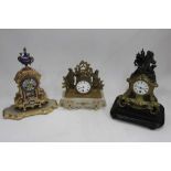 Three French mantel clocks, including an ormolu and onyx figural example, an ormolu and spelter cher