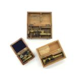 Three Miniature Antique Brass Microscopes in wooden cases