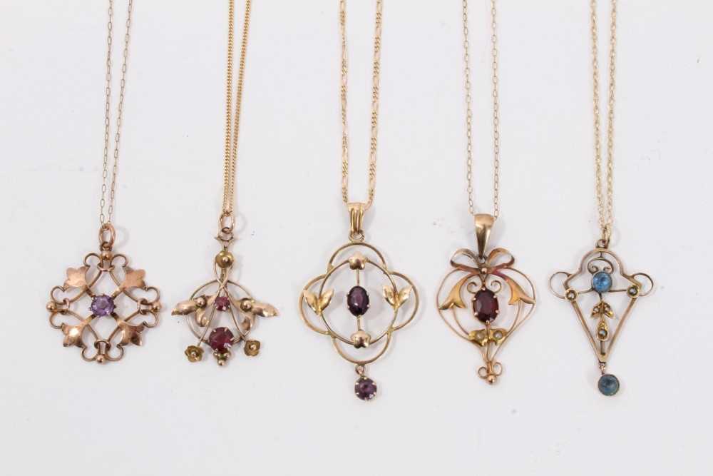 Five Edwardian 9ct gold gem set open work pendants on 9ct gold chains