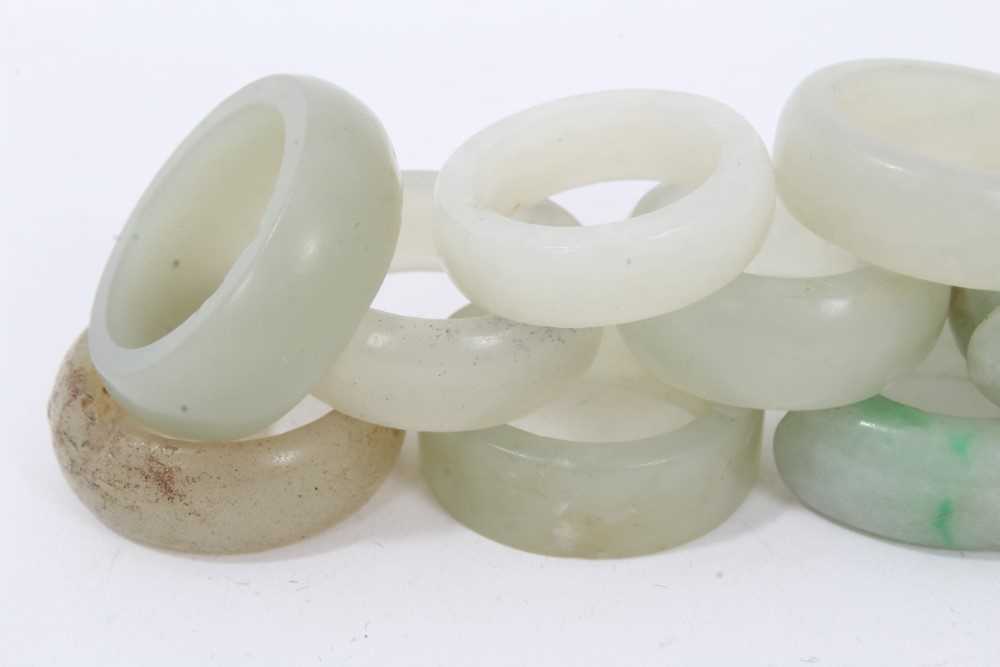 Collection of 16 Chinese polished green hard stone/ jade rings - Image 2 of 5