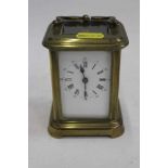 Brass carriage clock with white enamel dial and swing handle