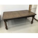 Early 20th century oak extending dining table, the rounded rectangular wind out top with relief carv